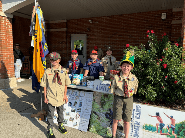Scout Boy Scouts with popcorn at a fundraising booth.
