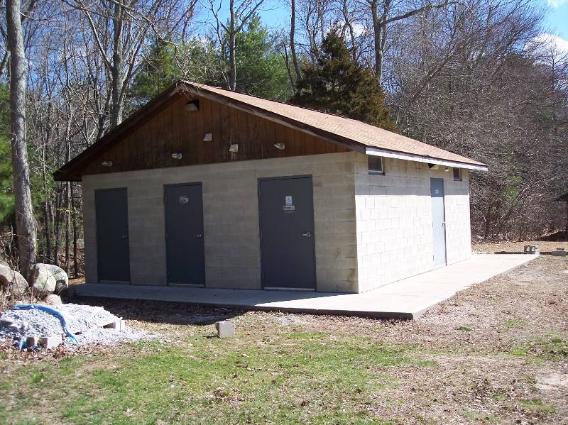 Restroom building at Camp Aquapaug, ideal for outdoor camping and scout activities.