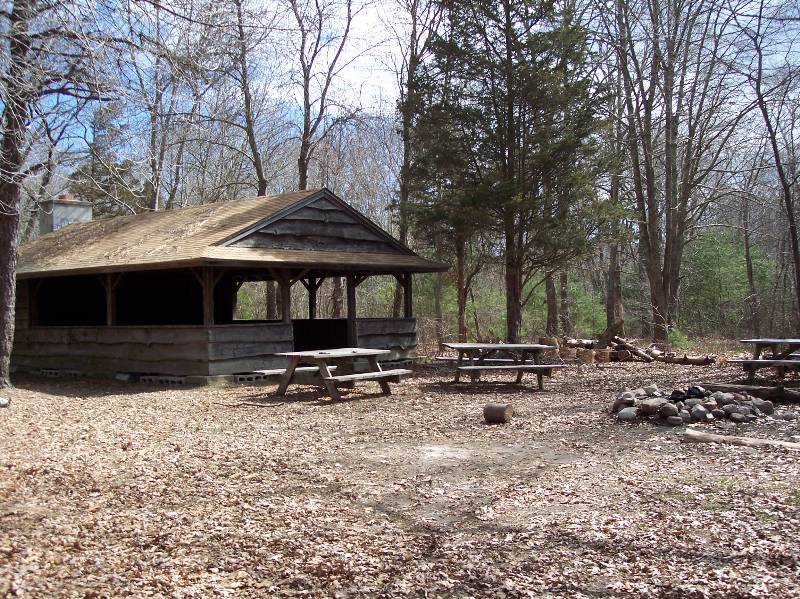 Shelter at Camp Aquapaug, part of Narragansett Council, surrounded by trees.