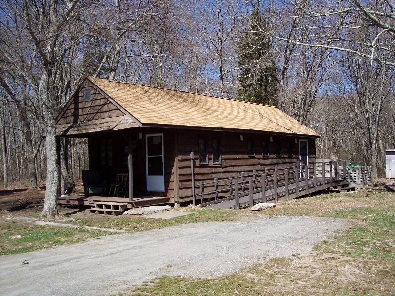 Cabin at Camp Aquapaug with wooden exterior and accessible ramp.