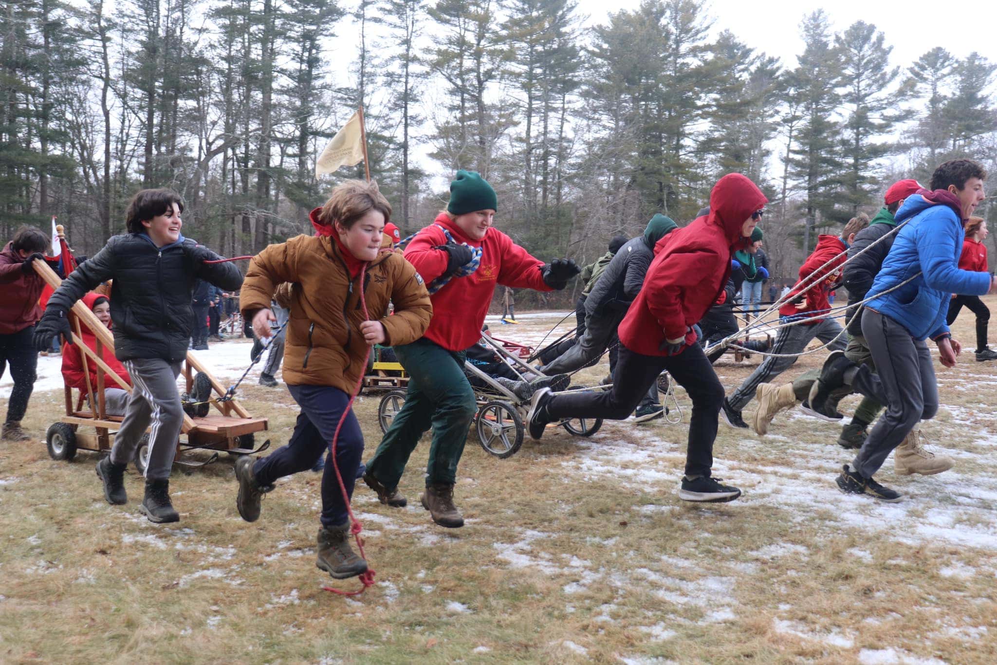 Scouts pulling a sled through the snow at a Klondike Derby